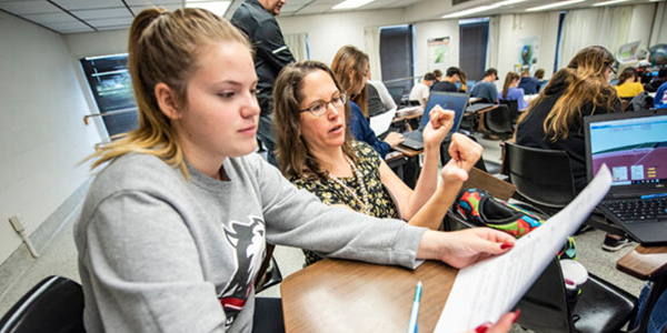 Associate Professor Nicole LaDue works with a student in her GEOL120 class.